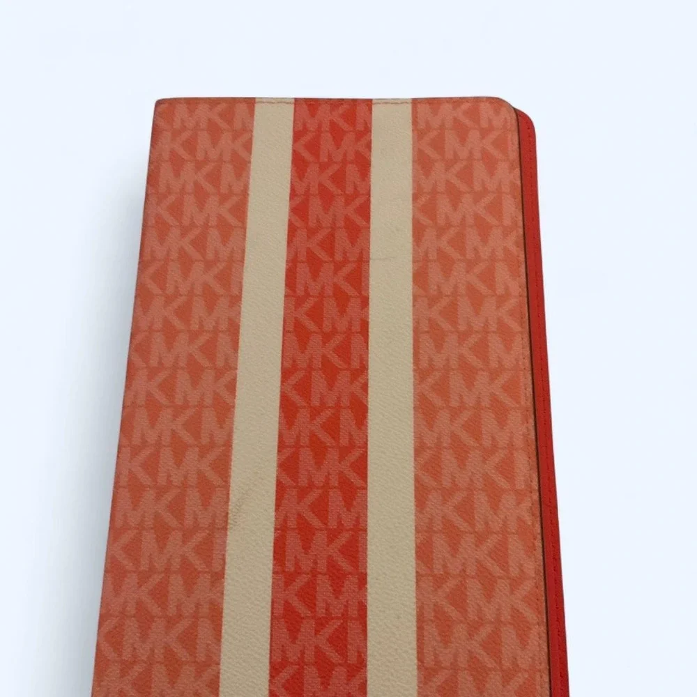 MK pink/red leather organizer/planner cover with repeating MK monogram pattern